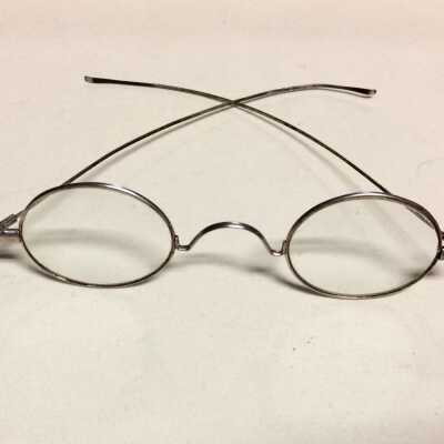 Eyeglasses in brown imitation leather case, early 1900s