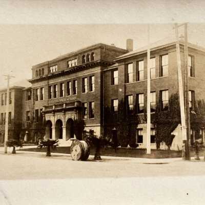 Photo postcard of main facade Alameda High School, early 1900s