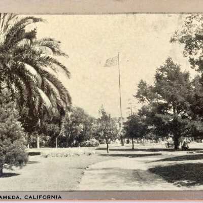 Postcard of foliage, a path, and a flagpole in Washington Park, c. 1940s-1950s