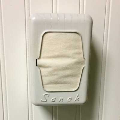 Paper collar protector dispenser used in the Corica Barer Shop, before 1998
