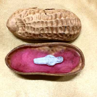 Miniature frozen charlotte-style doll in peanut shell box, early 1900s