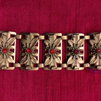 Gold plated brass buckle of 5 panels with floral designs and red glass, 1930/1940