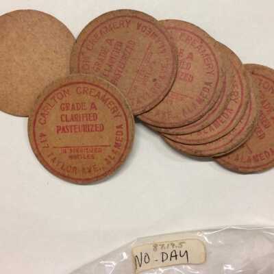 Cardboard milk bottle caps from the Carlton Creamery, before 1923