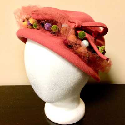Coral Easter Bonnet with bow and veil and colored flowers, 1945