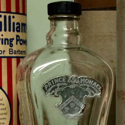 Glass bottle with labels stating Prince Monaco and Monte Carlo, and Black Tulip.