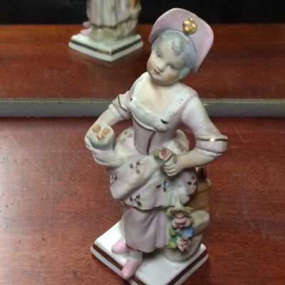 Porcelain figurine of a young girl in 18th century costume, c. 1900s