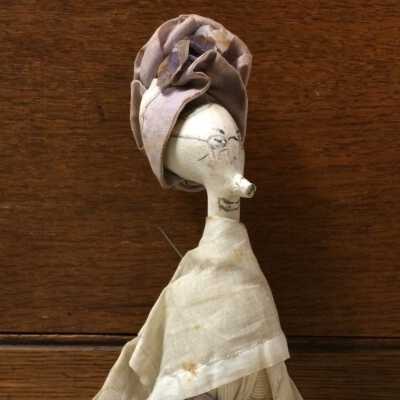 Clay pipe doll, mounted on a darning cotton spool