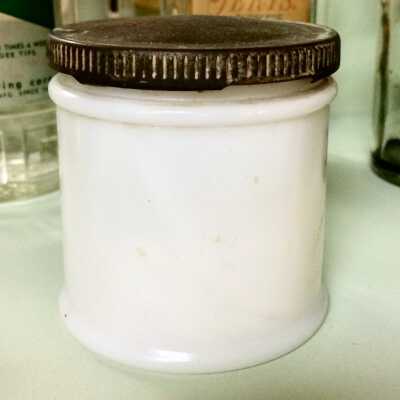 Milk glass jar with gold finish metal screw top from Frank's Barber Shop