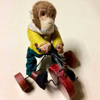 Dressed toy Monkey on red tricycle of Frank H. Perkins, c. 1930s