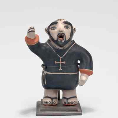 Singing Priest Figure with a Cross