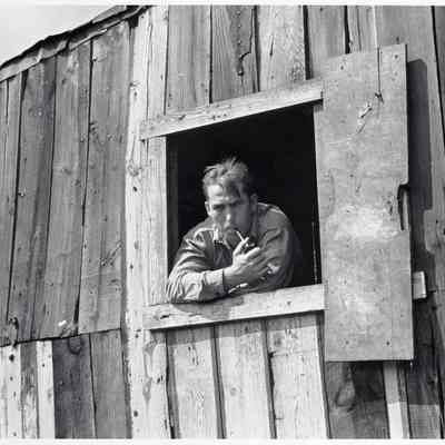 Coal miner looks out of window in his home, Bertha Hill, Scotts Run, West Virginia