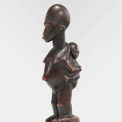 Woman Holding Infant on Her Back
