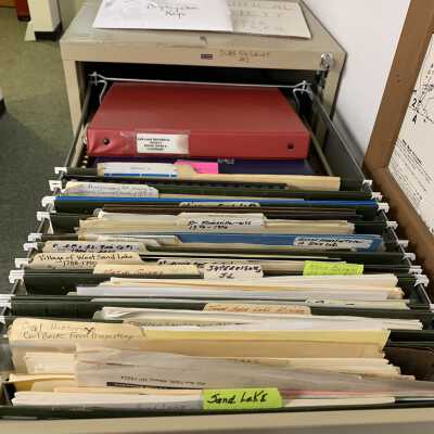 SLHS File Cabinet 2 - Drawer 1: Stores various Sand Lake and Sand Lake area histories and articles.