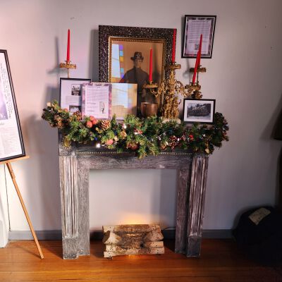 Mantle and Fireplace Display: The display primarily features a charcoal portrait of Colonel Jacob Shmoder / Smauder who was a Sand Lake Civil War Veteran, Moscow, a Civil War horse which was buried near its master in the Averill plot of the Sand Lake Union Cemetery, the appointment of Sand Lake resident William Pohl as a Corporal in the Union Army, and Albert Redmond Fox family-owned items.  Refer to the Shmoder, Pohl, and Fox entries in this system for more information.