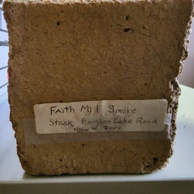 Faith Mills Smokestack Brick - Photo 3: End view including a notation of its donation to the Town by Nancy W. Davis.