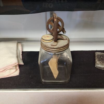 Display case of Averill Family-Owned Items - Close up 2: For Heaven's Sake use Evan's Toppings cake icing and ice cream mixing jar and mixer.