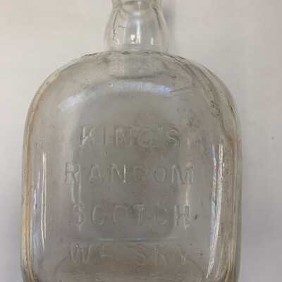 King's Ransom scotch whiskey bottle side view: Additional embossing on the reverse side includes, "Round the World Blend," and bottom includes, "Whiteley & Co., Scotland."