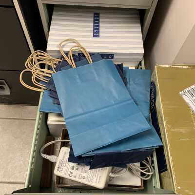 SLHS-FC4 D3: Stores SLHS stationery (envelopes, letterhead, etc.), gift bags, and SLHS Logo stickers for identifying items like the one that appears on the front of the cabinet.
