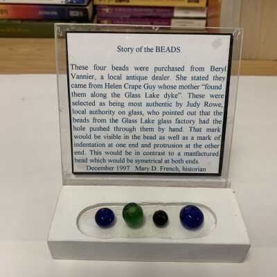 Rensselaer Glass Factory Glass Beads: Reportedly found along Glass Lake Dyke by the mother of Helen Crape Guy, donated to SLHS by Beryl Vannier, and verified as authentic by local glass authority Judy Rowe per Mary D. French for the reasons cited above.