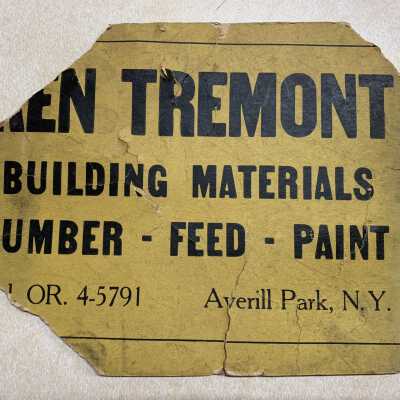 Ken Tremont Lumber Delivery Sign - Original: JPG photo.  Original remains of a sign that Tremont Lumber customers would place on or near their home or farm when expecting a delivery from Tremont Lumber.  Ken Tremont's daughter Jackie Tremont brought this original version to an April 12, 2022, SLHS Show and Tell Program Presentation.