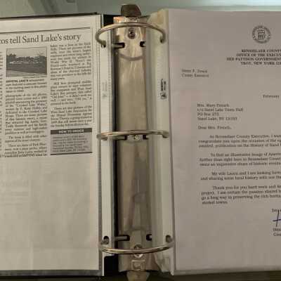 NAB Pages 7 and 8: Left continuation of the February of 2001 Times Union article regarding the Sand Lake book.  Right congratulatory letter from Rensselaer County Executive Henry Zwack to Mary French regarding the Sand Lake book.