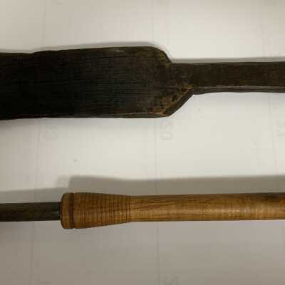 Glass Making Paddle - Large and Unknown Tool: A paddle is a wooden board with handle used for flattening glass, particularly the base or foot of a vessel. A paddle becomes charred with use against hot glass. Occasionally, a glassmaker’s assistant will protect the glassmaker from excess radiant heat by using the paddle as a shield.  The use of the other tool is uncertain.