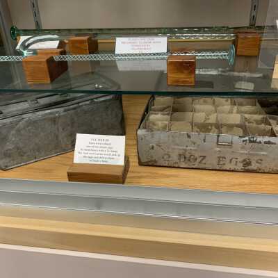 Various Artifacts and Photos Display - Left Side Close Up Bottom Shelves - 3: Various Artifacts and Photos Display - Left Side Close Up Bottom Shelves -3.  Includes glass canes, a glass pipe, Native American Artifacts, egg mailers, and two Troy and New England Railroad Trolley spikes.