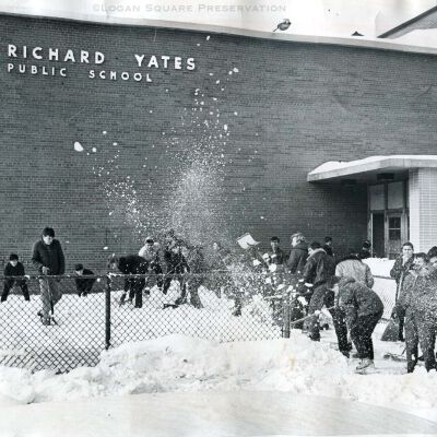 26 boys shovel snow around school