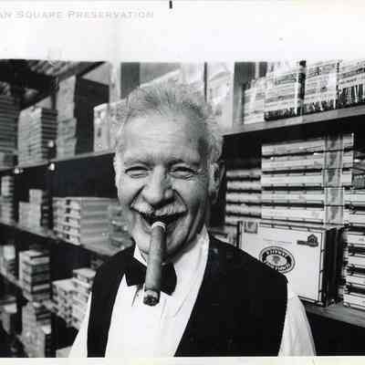 Harry Hacker enjoys a good cigar in his tobacco shop