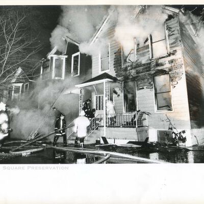 Firefighters work to extinguish a blaze that spread through a series of two-flat buildings