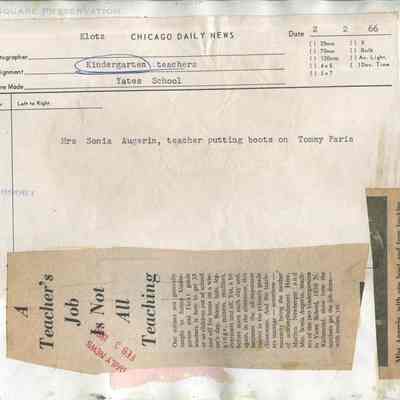 Mrs. Sonia Augerin, teacher putting boots on Tommy Paris: Back of photograph