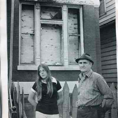 Mike Szymkowski and his daughter Kathy stand in front of the home where they used to live