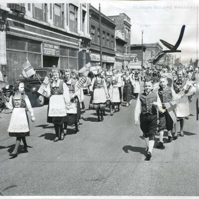 Children in native Norwegian costumes march along North Av.