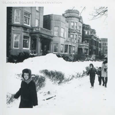 Children walking on snowy sidewalk