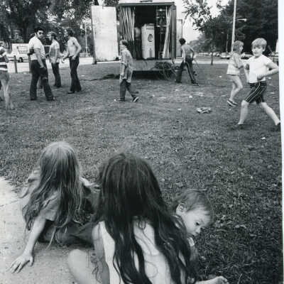 Children watch as workmen pack up carnival at Kedzie and Logan Blvd
