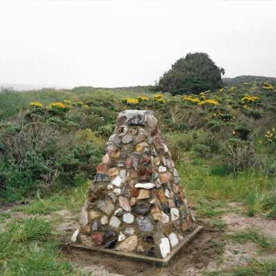 The completed monumnet on Coreopsis Hill for Joseph Enos and Mary Barcellos Enos for allowing people to lead hikers on their propertyto see the beautiful dune flowers, monument idea by Kathleen Goddard Jones, designed and constructed by Jack Beigle, Al Spierling, Norm Hammond, and Hal Shartz with Kathleen Goddard Jones supervising, 1994 - 4" x 6" color photograph