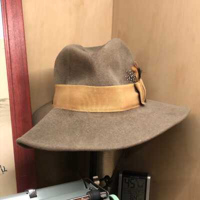 Wool hat, brown-gray with tan band and feathers, Kathleen Goddard Jones's personal hiking hat  (in display case)