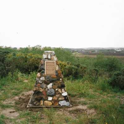 The completed monumnet on Coreopsis Hill for Joseph Enos and Mary Barcellos Enos for allowing people to lead hikers on their propertyto see the beautiful dune flowers, monument idea by Kathleen Goddard Jones, designed and constructed by Jack Beigle, Al Spierling, Norm Hammond, and Hal Shartz with Kathleen Goddard Jones supervising, 1994 - 4" x 6" color photograph