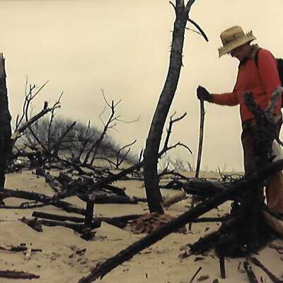 Kathleen Goddard Jones in the Dunes with footprints, photo taken by Liz Scott-Graham, 1987 - 8" x 12" color photograph
