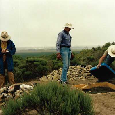 Pictures of the construction sequence of the monument on Coreopsis Hill for Joseph Enos and Mary Barcellos Enos for allowing people to lead hikers on their property to see the beautiful dune flowers, monument idea by Kathleen Goddard Jones, designed and constructed by Jack Beigle, Al Spierling, Norm Hammond, and Hal Shartz with Kathleen Goddard Jones supervising, 1994 - 4" x 4" color photograph
