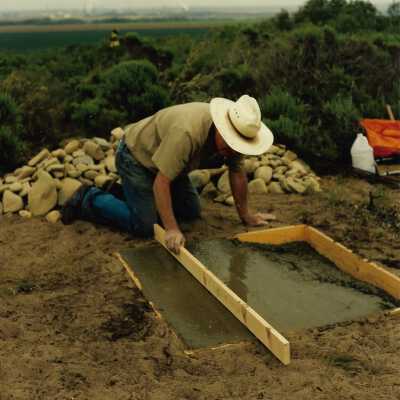 Pictures of the construction sequence of the monumnet on Coreopsis Hill for Joseph Enos and Mary Barcellos Enos for allowing people to lead hikers on their propertyto see the beautiful dune flowers, monument idea by Kathleen Goddard Jones, designed and constructed by Jack Beigle, Al Spierling, Norm Hammond, and Hal Shartz with Kathleen Goddard Jones supervising, 1994 - 4" x 4" color photograph