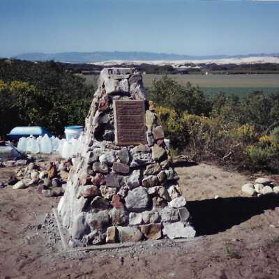 The completed monument on Coreopsis Hill for Joseph Enos and Mary Barcellos Enos for allowing people to lead hikers on their propertyto see the beautiful dune flowers, monument idea by Kathleen Goddard Jones, designed and constructed by Jack Beigle, Al Spierling, Norm Hammond, and Hal Shartz with Kathleen Goddard Jones supervising, 1994 - 3.5" x 5" color photograph