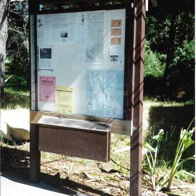 Dune information board with maps, in photo album - Undated 3.5" x 5" color photograph
