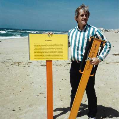 Instalation of Warning Signs concerning nearby Unocal's Guadalupe Oil Fields contamination of water and sands at Oceano Dunes SVRA, in photo album - Undated 3.5" x 5" color photograph
