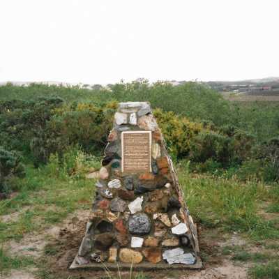 The completed monumnet on Coreopsis Hill for Joseph Enos and Mary Barcellos Enos for allowing people to lead hikers on their propertyto see the beautiful dune flowers, monument idea by Kathleen Goddard Jones, designed and constructed by Jack Beigle, Al Spierling, Norm Hammond, and Hal Shartz with Kathleen Goddard Jones supervising, 1994 - 4" x 6" color photograph
