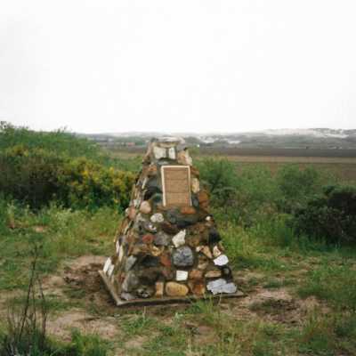 The completed monumnet on Coreopsis Hill for Joseph Enos and Mary Barcellos Enos for allowing people to lead hikers on their propertyto see the beautiful dune flowers, monument idea by Kathleen Goddard Jones, designed and constructed by Jack Beigle, Al Spierling, Norm Hammond, and Hal Shartz with Kathleen Goddard Jones supervising, 1994 - 4" x 6" color photograph