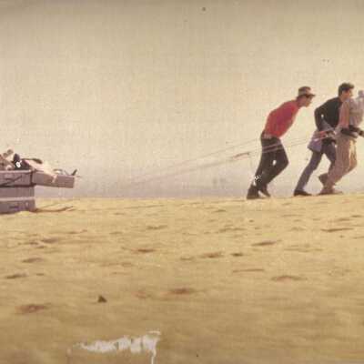1997 Ten Commandments excavation. 3 men carying equipment to excavation site.