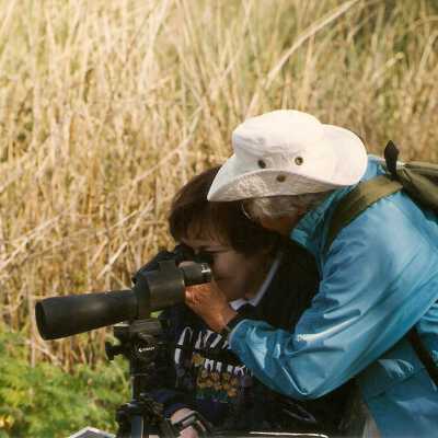 Walk for physically disabled 1994. Betty Usher helps a participant with binoculars.