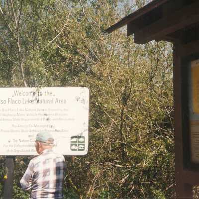 Installation of signs on beaches 3/1996. Jim Neuschwander at Oso Flaco Lake.