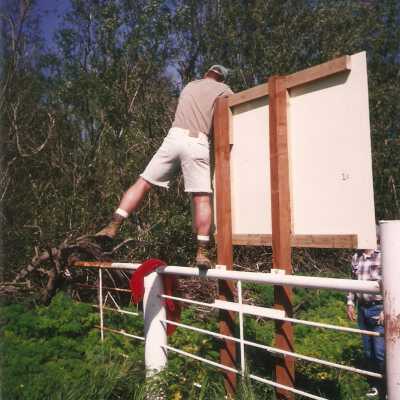 Installation of signs on beaches 3/1996. Pete St. John and Jim Neuschwander at Main St entrance gate.